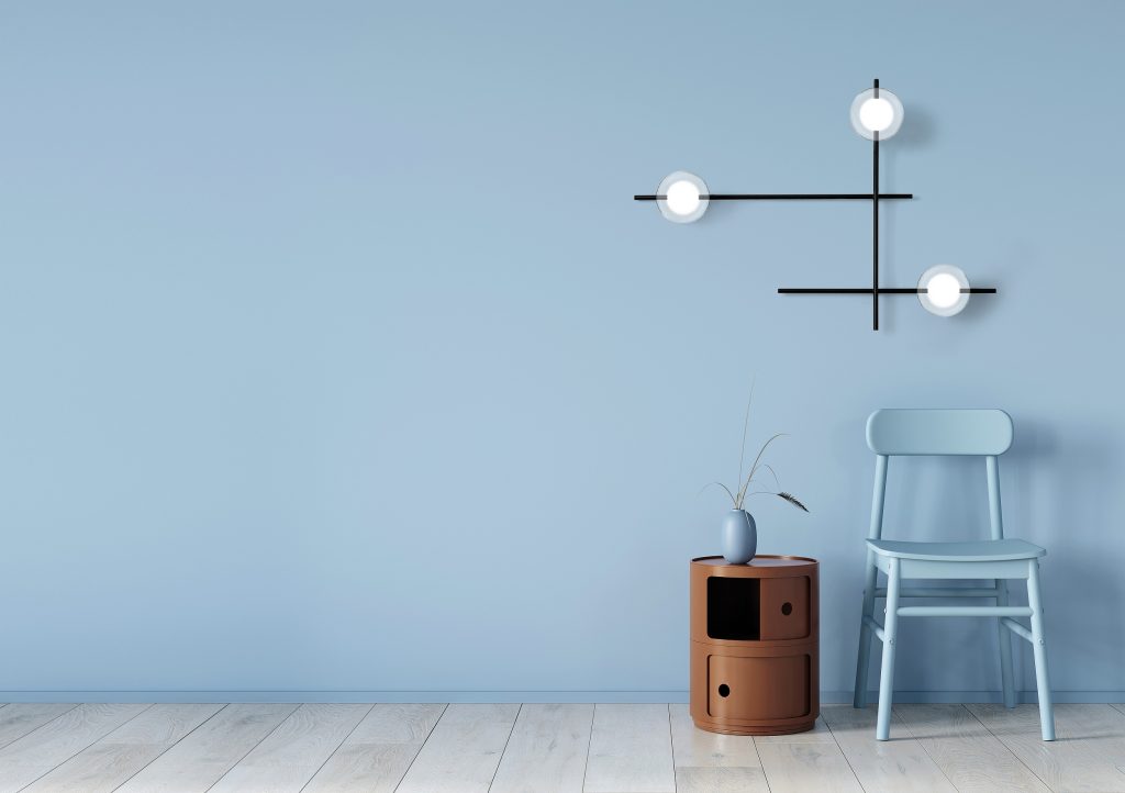 Interior in light blue with a chair and terracotta bedside table