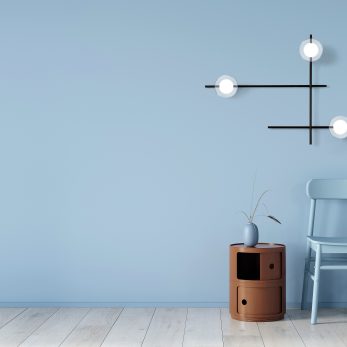 Interior in light blue with a chair and terracotta bedside table