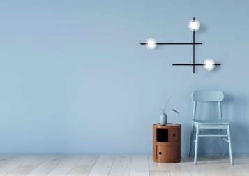 Interior in light blue with a chair and terracotta bedside table