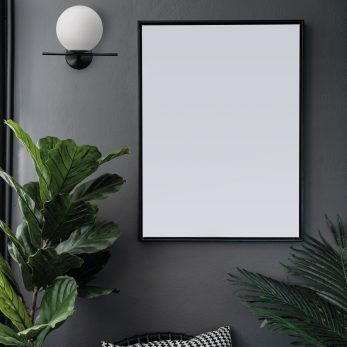 Compostion empty natural wooden frames setting on gray painted w
